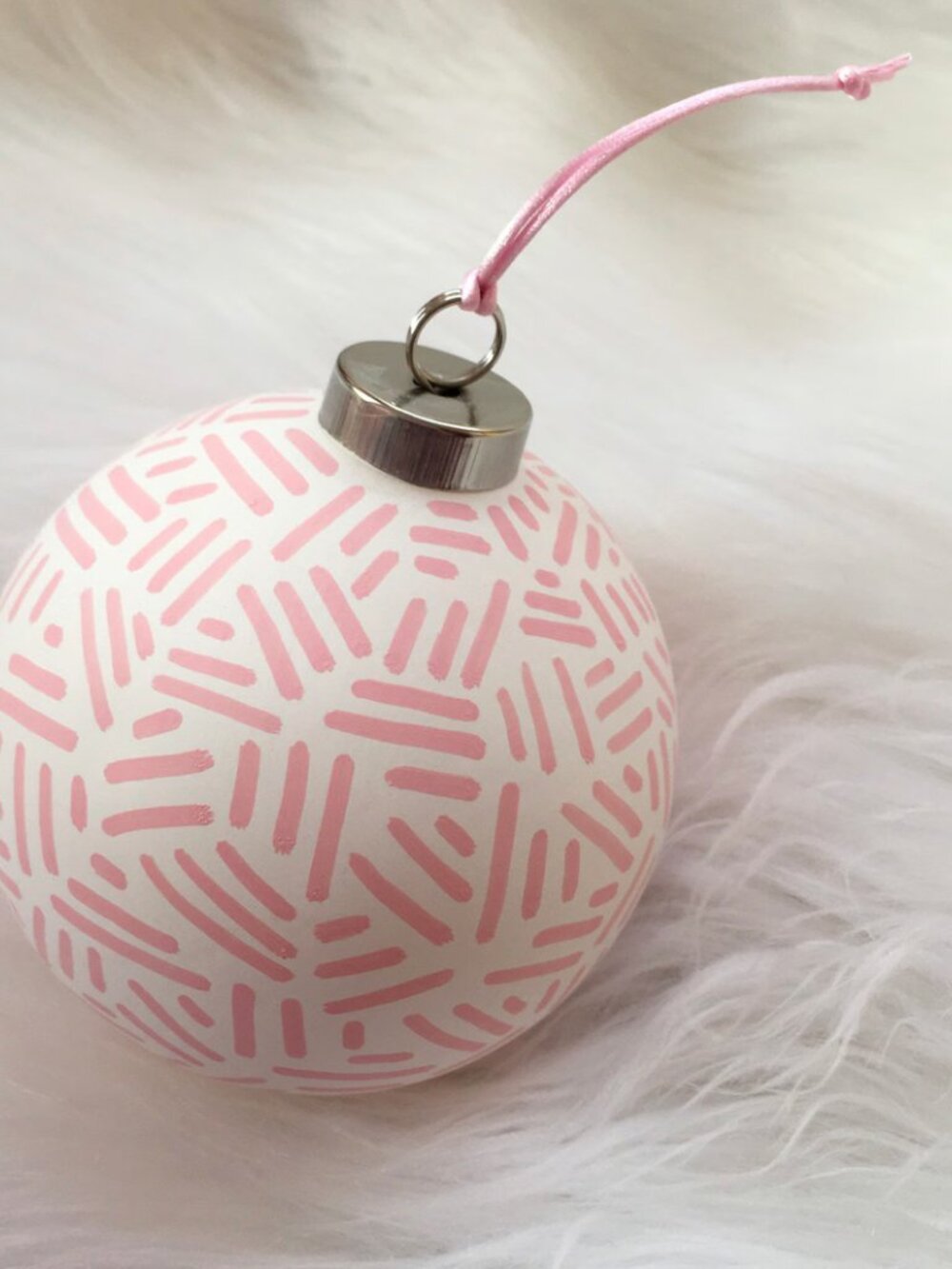 TWO ceramic ornaments pink and white print